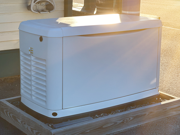 A Home Standby Generator installed at the backyard of a house. An air-cooled Generator powered by natural gas or liquid propane for residential use
